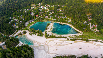 Aerial view of crystal clear lake surrounded with town.