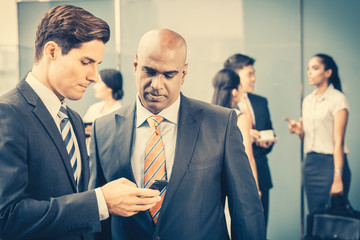 Mixed Asian and Caucasian business team meeting on terrace on front of their office