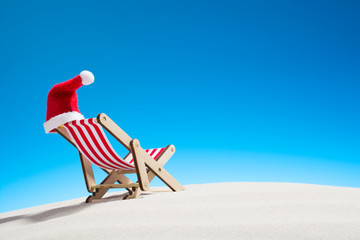 Christmas on the beach: a lounge chair with a Santa hat