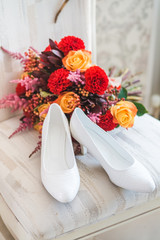 wedding shoes and bouquet on chair