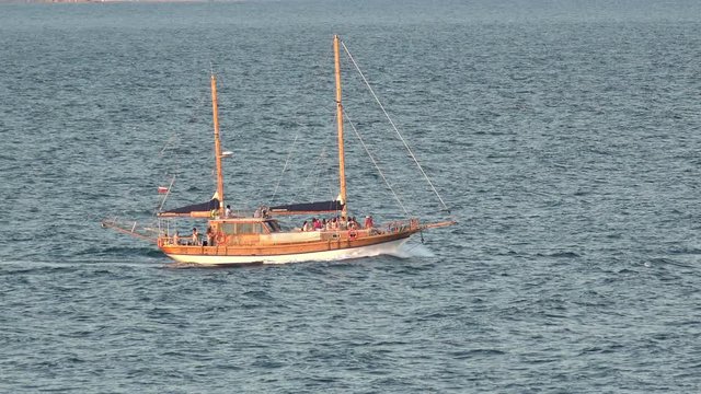 Old sail boat on sea horizon. Refugees and Migrants aboard 