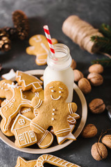 Milk and cookies. Gingerbread  cookies on a gray background.  Christmas cookies.  Ginger men