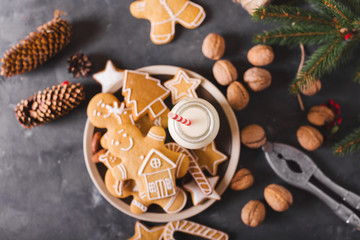 Milk and cookies. Gingerbread  cookies on a gray background.  Christmas cookies.  Ginger men