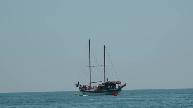 Old sail boat on sea horizon. Refugees and Migrants aboard 