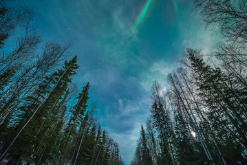 Green and Blue aurora borealis mixed with wispy clouds in triangular pattern 