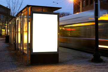 Blank billboard on bus stop at night