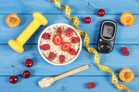 Glucose meter for checking sugar level, oatmeal with fruits, centimeter and dumbbells, diabetes and healthy lifestyle