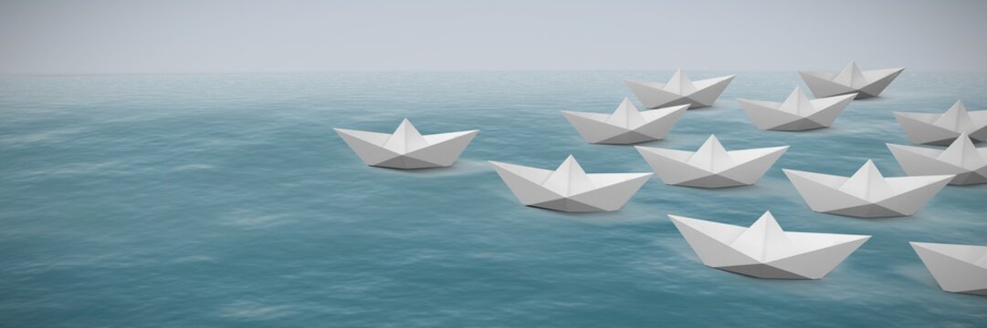 Composite image of paper boats arranged on white background