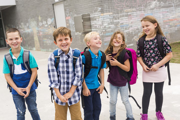 Great group Portrait Of School Pupil Outside Classroom Carrying Bags