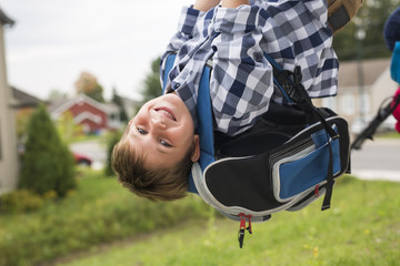 Great Portrait Of School Pupil Outside Classroom Carrying Bags