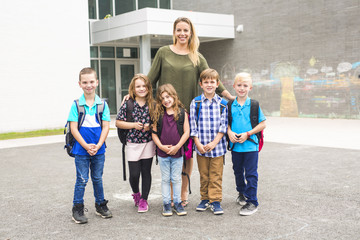 Great Portrait Of School Pupil Outside Classroom Carrying Bags with teacher