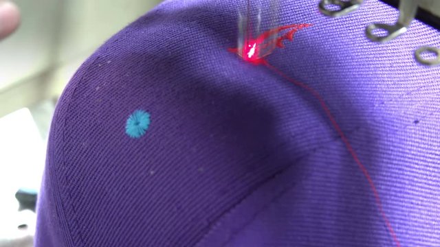 Hat Embroidery machine. Sewing machine embroider signs. Sewing needle stitching