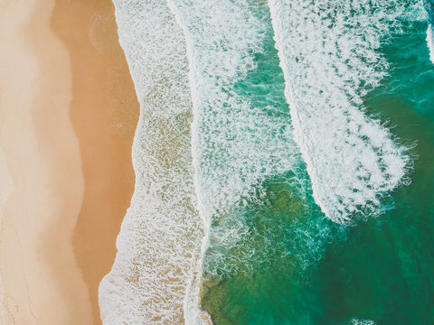 Aerial view of waves crashing on beach