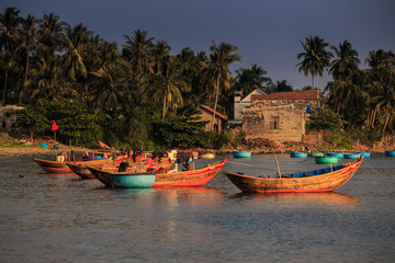 Fototapeta na wymiar Different Fishing Boats Moor in Calm Harbor in Vietnam