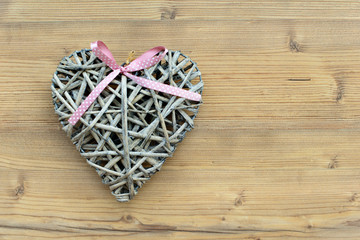 A heart made of straw on a wooden background