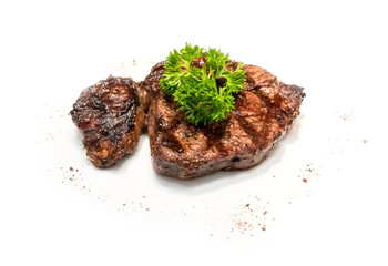 grilled beef steaks with spices on white plate