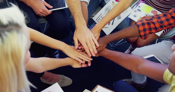 Group of executives forming hand stack 