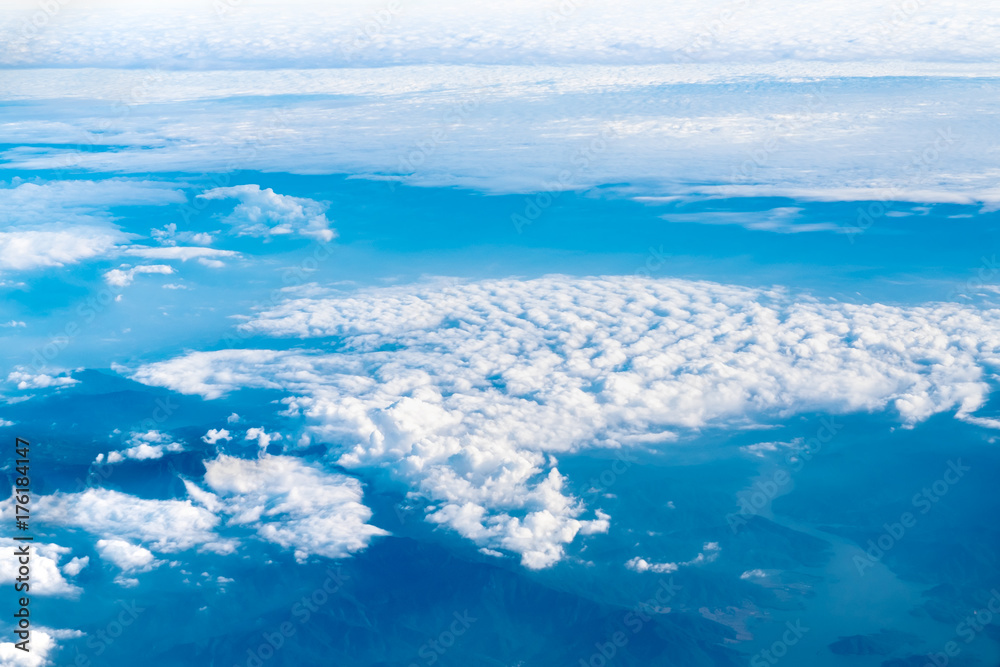 Canvas Prints aerial view of airplane window looking down to cloudy and mountain land ,nature background