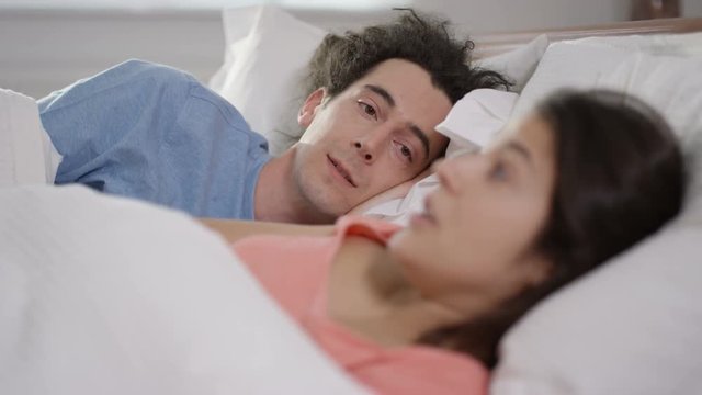  Couple having a serious conversation in bed