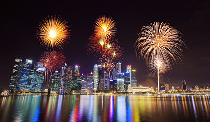 firework over central business district building of Singapore city at night