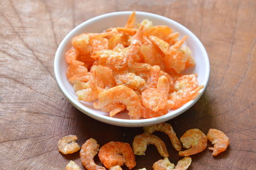 dry salted shrimp in cup on wooden table