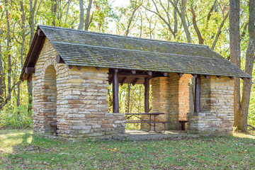 Rustic stone and log picnic shelter