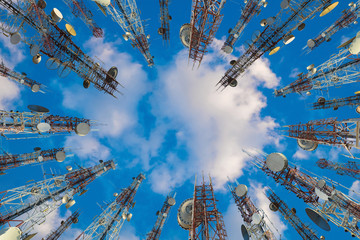 Antenna of cellular cell phone and communication system tower with cloud on center blue sky, Telecommunication tower perspective. technology concept.