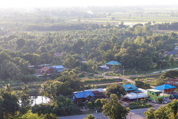 Above the rural village with trees.