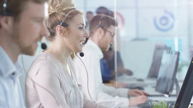  Friendly customer service operators taking calls in busy call center