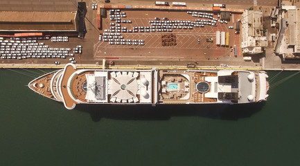 Huge large mega ULCV container ship sails on open water fully loaded with containers and cargo - aerial 4k view