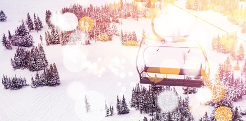 Ski lift over snow covered mountain