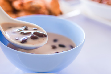 Sweet Sticky Rice & Black Beans in Coconut Milk, show spoon close-up, Thai dessert, Thailand