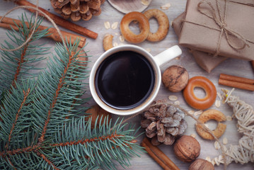 Arrangement of Christmas winter foliage with coffee cup. Holiday background. Holiday Christmas still life with cup of coffee, chocolate