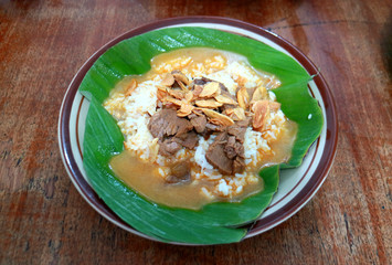 Nasi gandul. Traditional food from Pati, Central Java, Indonesia. Served with curry, ketchup and always accompanied with meat slices or eggs.