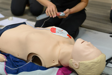CPR First Aid Training with CPR dummy in the class