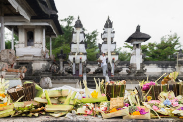 Traditional hindu balinese offerings as flowers, money and food in a basket in Pura Penataran Agung Lempuyang, Bali, Indonesia