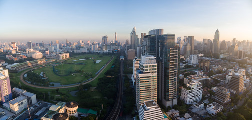 Fototapeta na wymiar Modern Skyscrapers Next To Sports Field In Central Bangkok, Thailand, Aerial Panorama Shot