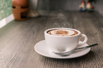 Coffee cup and coffee beans on wood table ,warm and good smell