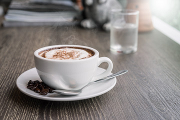 Coffee cup and coffee beans on wood table ,warm and good smell