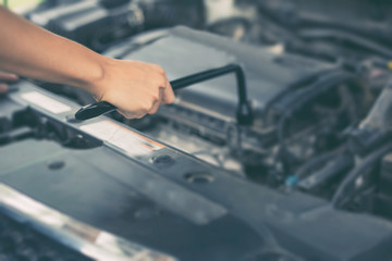 Asian women engineer holding a wrench in hand, prepared for the repairs cars on road