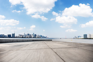 empty concrete floor with cityscape of modern city