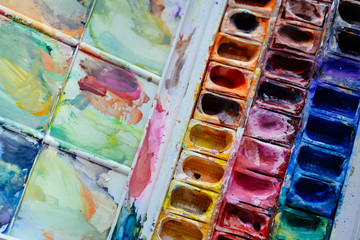 Watercolor paints. Tools for art, drawing and creativity. Nice photo with watercolor box for banners, web, sites, artist shops, advertising, design, posters, prints.