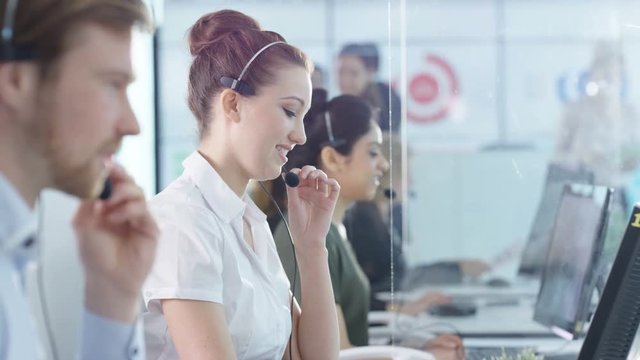  Friendly customer service operators taking calls in busy call center