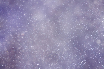 Snowfall texture of snowflakes on blurred background