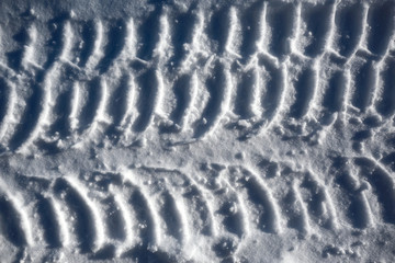 Footprints in the snow from the car