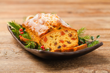 Christmas fruitcake. Natural wooden background.