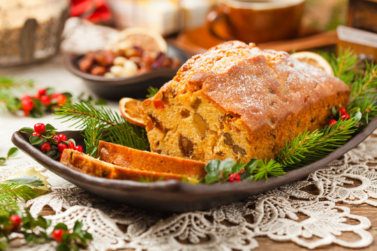 Christmas fruitcake. Natural wooden background.