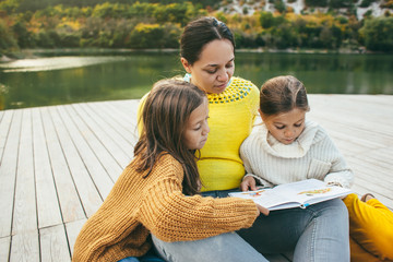 Family spending time together by the lake © Alena Ozerova