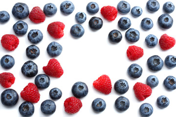 mix of blueberries, raspberries isolated on white background. top view