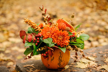 Beautiful pumpkin with an autumn flower composition
